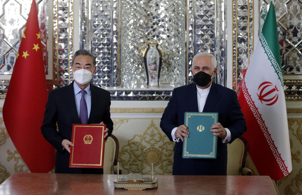 Iranian Foreign Minister Mohammad Javad Zarif (R) and his Chinese counterpart Wang Yi, pose for a picture after signing an agreement in the capital Tehran, on March 27, 2021. - Iran and China signed what state television called a "25-year strategic cooperation pact" on today as the US rivals move closer together.
The agreement, which has been kept almost entirely under wraps, was signed by the two countries' foreign ministers, Mohammad Javad Zarif and Wang Yi, an AFP correspondent reported. (Photo by - / AFP)