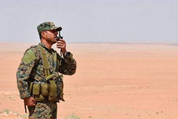 A member of the Syrian government forces talks on a walkie-talkie in Bir Qabaqib, more than 40 kilometres west of Deir Ezzor, after taking control of the area on their way to Kobajjep in the ongoing battle against Islamic State (IS) group jihadists on September 4, 2017.
Syria's army are fighting the Islamic State group on the edges of Deir Ezzor seeking to break the siege of a government enclave and oust the jihadists from a key stronghold. / AFP PHOTO / George OURFALIAN        (Photo credit should read GEORGE OURFALIAN/AFP via Getty Images)