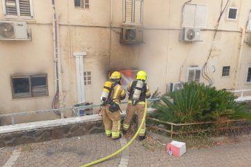 Bomberos israelíes junto a un edificio dañado en Kiryat Shmona